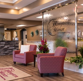 a hotel lobby area with chairs and a reception table