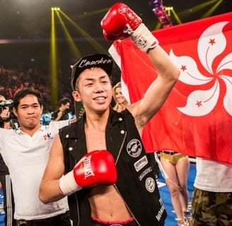 Photo of Hong Kong boxer Rex Tso in front of a Hong Kong flag