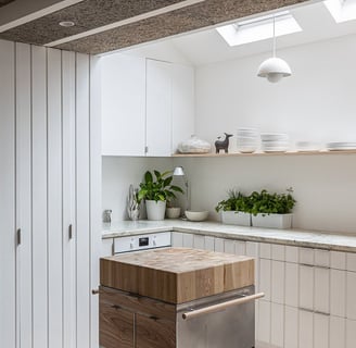 a kitchen with a wooden table and a dishwasher