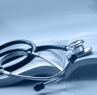 An open medical book with a stethoscope on top of it