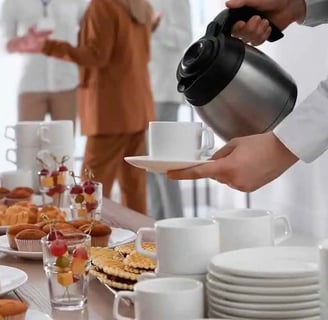 a person is pouring tea into a cup of coffee