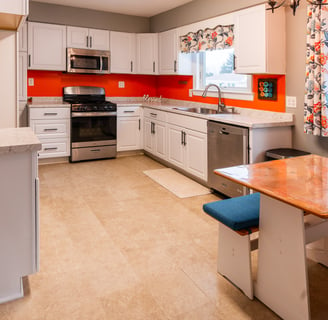 a kitchen with a table and chairs and a table