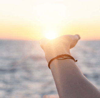 a person holding a wrist watch and a wrist watch