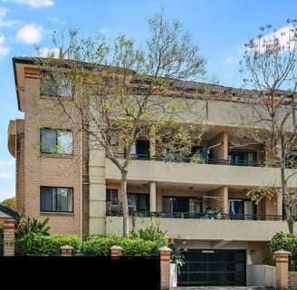 a large apartment building with a large balcony and a garage
