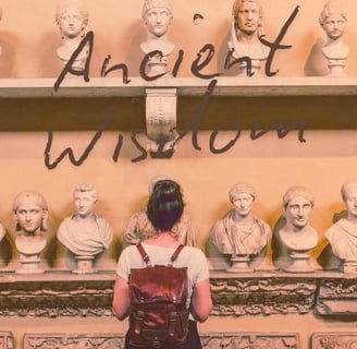 a woman standing in front of a display of ancient sculpture