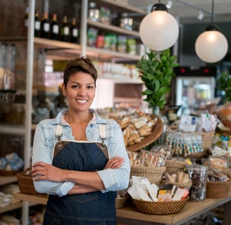 A happy store owner standing in her shop.