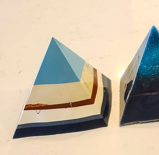 a row of five pyramid shaped resin pieces