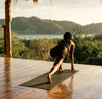 yoga pose overlooking jungle and ocean