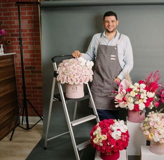 a man in a apron and aprons holding flowers