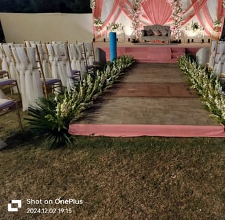 a wedding ceremony with a pink and white floral arrangement