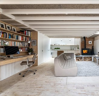 a living room with a couch and a desk