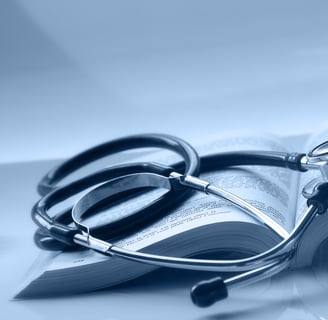 An open medical book with a stethoscope on top of it