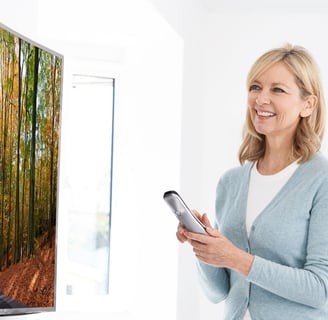 a woman holding a remote control control device