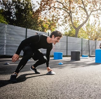 a man over 40 in a black compression tights exercising outdoors