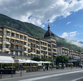 Victoria Jungfrau Hotel in Interlaken Switzerland with paragliders over head