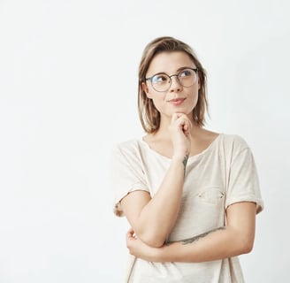 Thoughtful Young Woman with Glasses Looking Aside