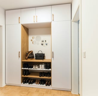 a wardrobe with a lot of shoes and a purse