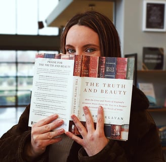 Ashleigh Marie model holding the book "The Truth and Beauty" in front of her face.