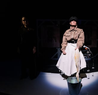 A white woman in a military cap and jacket, and white shirt, flanked by two very shaded people