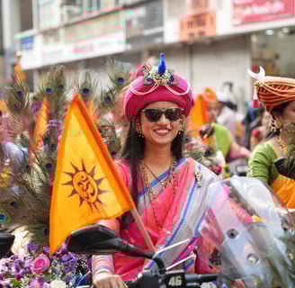 woman in maharastrian traditional outfit riding a motorbike in girgaon gudipadwa shobhayatra 2025