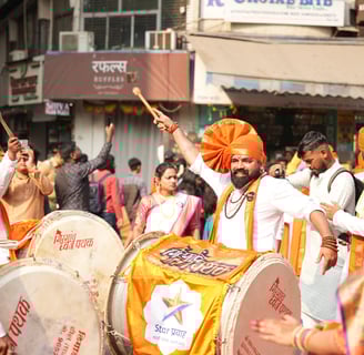 man playing dhol  in girgaon gudipadwa shobhayatra 2025