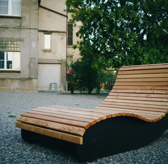 a wooden chaise lounger with a wooden bench and a bench