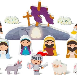 a group of wooden cutouts of Jesus and empty tomb