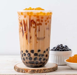 bubble tea with egg pudding, featuring tapioca pearls and creamy pudding chunks in a transparent cup with a straw