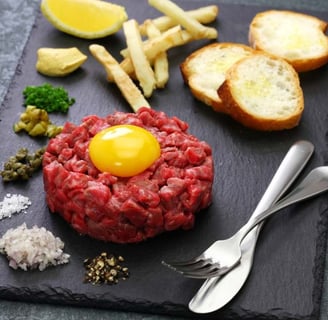 Close-up of a classic tartare dish featuring finely diced ingredients elegantly presented on a white plate