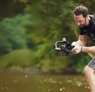 cameraman using gimbal in tropical forest