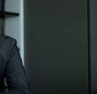 a man in a suit and tie is sitting at a table