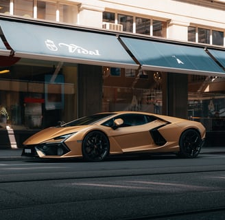 a gold colored lamborghini revuelto parked on the side of a street