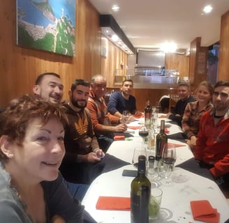 a group of people sitting around a table