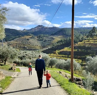 a man and two children walking down a path