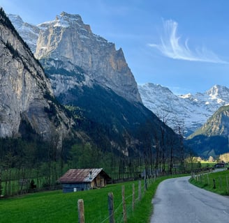 View looking up the Lauterbrunnen Valley in Switzerland with limestone cliffs towering above