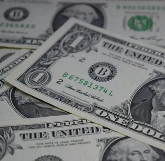 a pile of money bills and bills on a pile of money