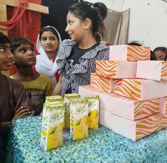 Abigail Amir Fazal distributing food and drinks to Sunday School children