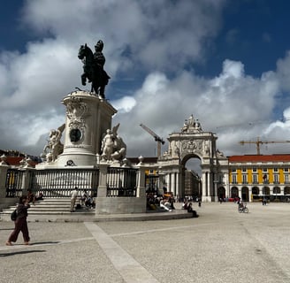 a statue of a man on a horse drawn carriage