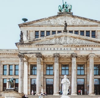 a building with a statue of a man on the steps in Berlin, Germany