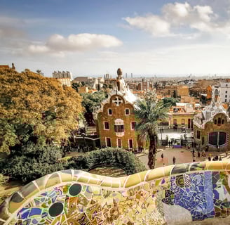 a view of a park Guell with a view of a city in Barcelona, Spain