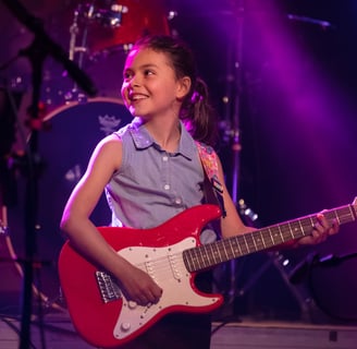 Gurnee Guitar Academy Guitar Lessons a girl with a guitar and a guitar