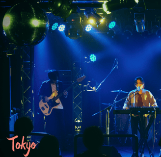 a man playing a guitar on stage with a band