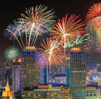 a city skyline with fireworks in the background