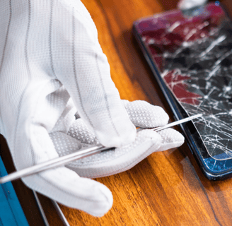 a person in gloves holding a pair of gloves and a pair of gloves