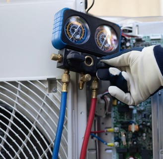 a person in a blue jacket and gloves holding a hose and a hose
