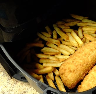 a person holding a fry fryer in a fryer