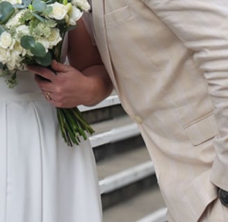 a man and woman kissing on the steps of a staircase