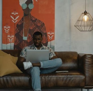 Man in Blue Denim Jeans Sitting on Brown Couch by Tima Miroshnichenko From Pexels