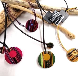 a bunch of necklaces with different colored circles