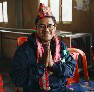 nepali man in traditional costume smiling